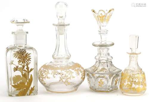 Four 19th century French glass decanters with gilt decoratio...