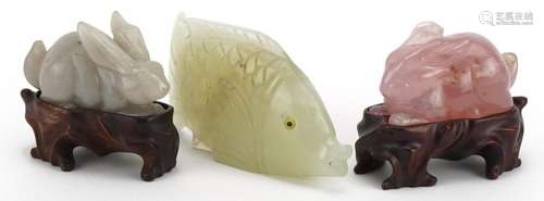 Two Chinese carved jade and rose quartz rabbits with hardwoo...