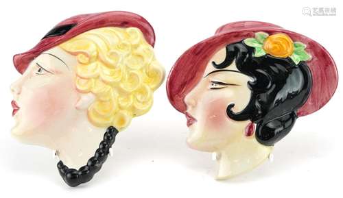 Pair of Art Deco pottery face plaques of females, the larges...