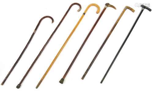 Six antique and later walking sticks with silver mounts incl...