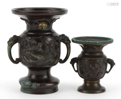 Two Japanese bronze vases, each with twin elephant head hand...