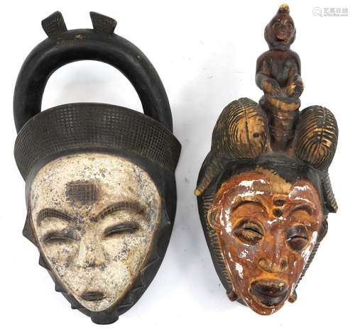 Two African tribal interest partially painted face masks, th...