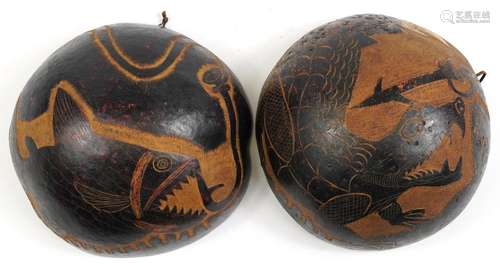 Pair of tribal interest coco de mer bum nut bowls carved wit...