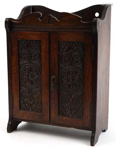 Arts & Crafts oak two door smokers cabinet with fitted i...