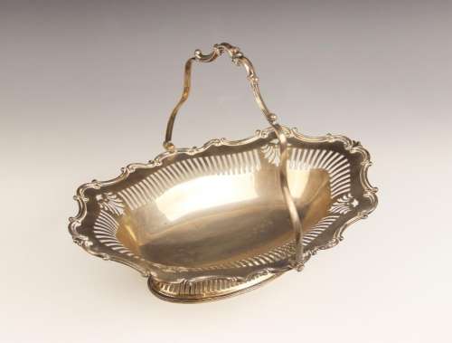 A George V silver swing-handled dish, of oval form with scro...