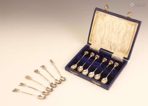A set of six silver coloured coffee spoons, each with termin...