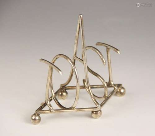 A Victorian silver toast rack in the manner of Christopher D...