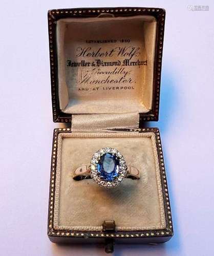 A sapphire and diamond cluster ring, the central oval mixed ...