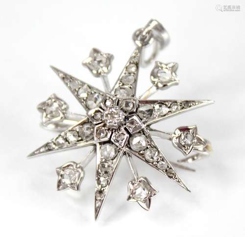 A diamond starburst pendant brooch, the tiered six pointed s...