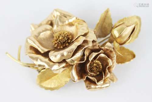 An 18ct gold floral spray brooch, designed as two rose gold ...