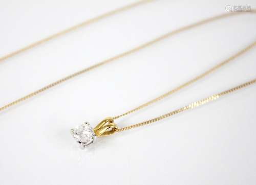 A diamond solitaire pendant, the round brilliant cut diamond...