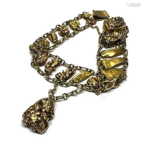 A gold coloured nugget bracelet, designed a graduated row of...