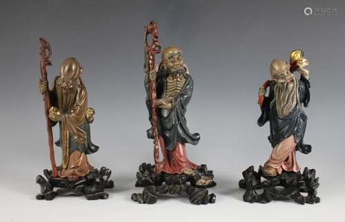 Three Fuzhou lacquer figures of Sanxing, 20th century, compr...