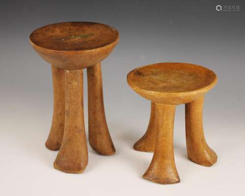 Two East African Pokot stools, Kenya, each with circular sea...