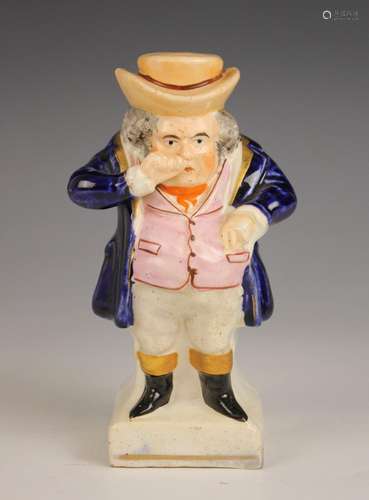 A Staffordshire figure modelled as a standing snuff taker, 1...