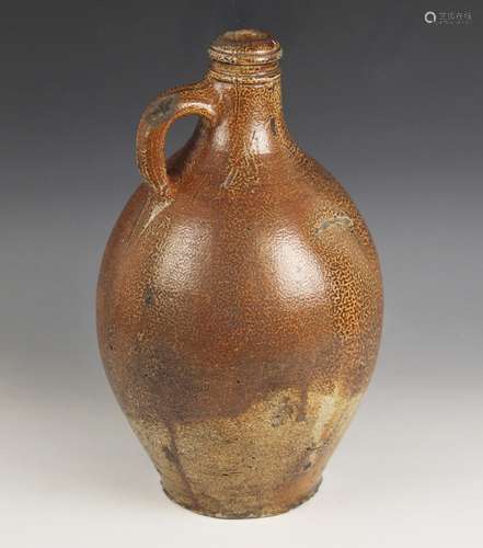 A large German stoneware salt glazed jug, 17th century, of l...