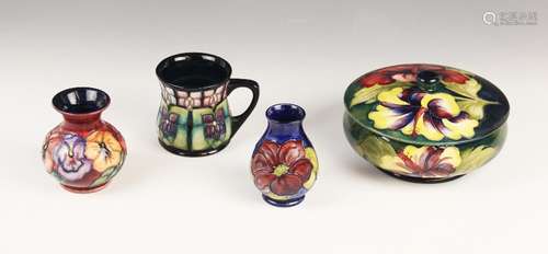 A Moorcroft bowl and cover in the Hibiscus pattern on a gree...