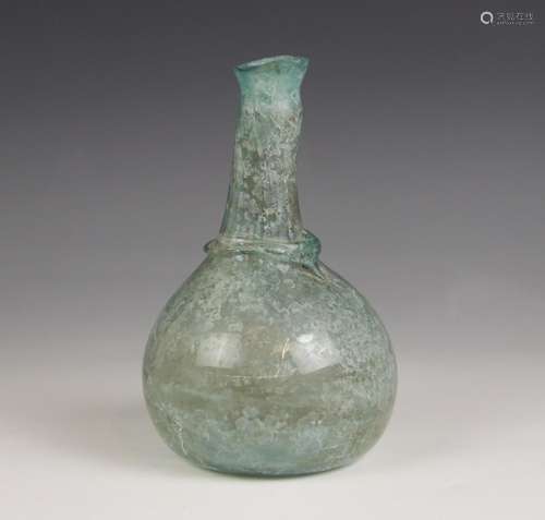 A Roman glass bottle, circa 1st Century AD, the spherical bo...