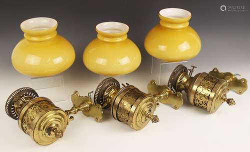 Three brass oil lamp wall sconces, late 19th century, the Du...