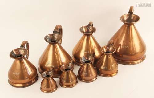 A set of seven graduated copper measures, 19th century, comp...