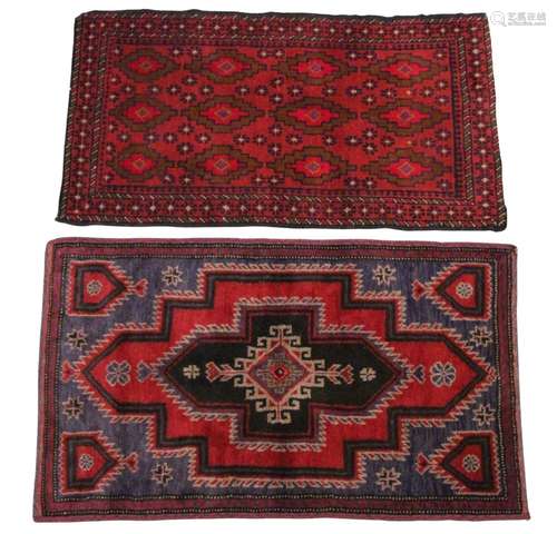 A Caucasian wool rug, in red and blue colourways, with centr...