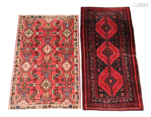 An Afghan wool rug, in red and blue colourways, the three ce...