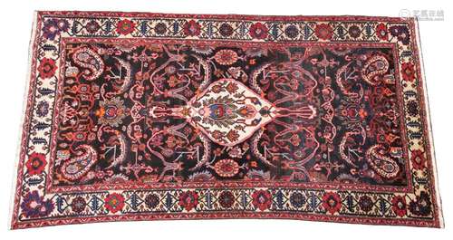 A deep ground Persian Ardebil carpet, in orange, brown and r...