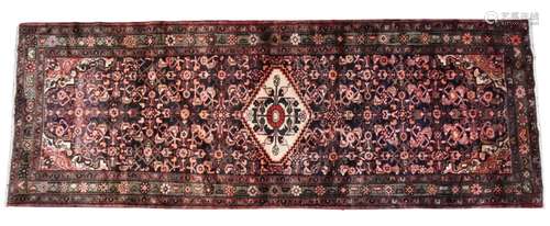 A Persian Hamadan runner, in deep brown and red colourways, ...