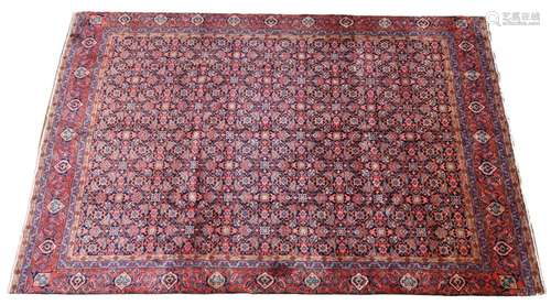 A Persian rich blue ground Sarouk carpet, the multiple repea...