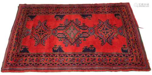 A Turkish hand knotted wool rug, in red, green and blue colo...