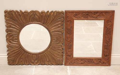 A carved oak wall mirror, 20th century, the rectangular fram...