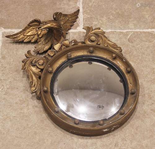 A Regency giltwood and gesso convex wall mirror, of diminuti...