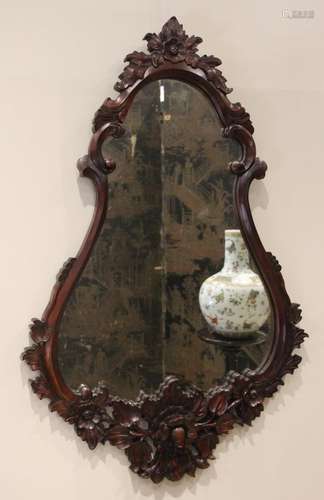 A carved hardwood Florentine style wall mirror, late 20th ce...