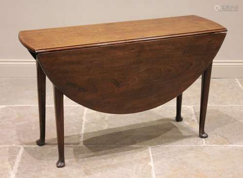 A George II mahogany drop leaf table, the oval top raised up...