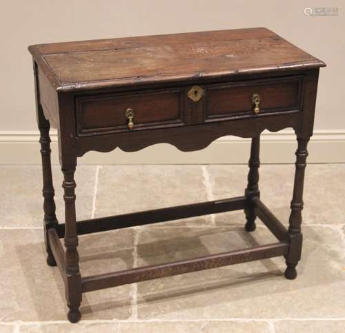 An 18th century oak side table, the moulded plank top above ...