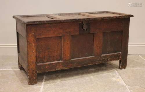 An 18th century oak panelled coffer, the three panel hinged ...