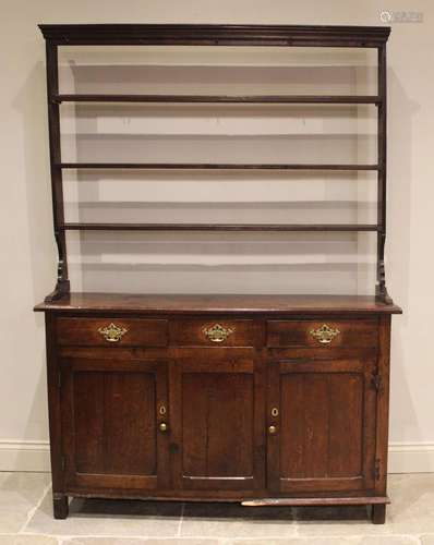 An 18th century oak dresser, the open plate rack with a moul...