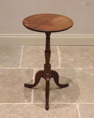 A George III mahogany tripod table, the circular top upon a ...