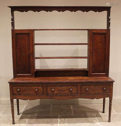 A George III oak and mahogany crossbanded dresser, the open ...