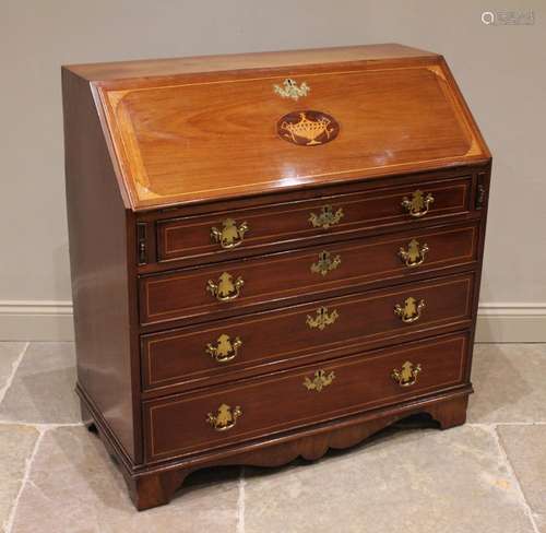 A George III mahogany bureau, the hinged fall front centred ...