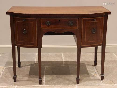 A George III mahogany bow front sideboard, the crossbanded t...