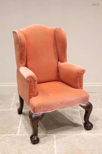 A George III style wing back armchair, 19th century, upholst...