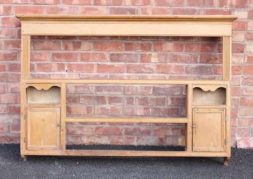 A Victorian pine wall rack, the moulded cornice above a plai...