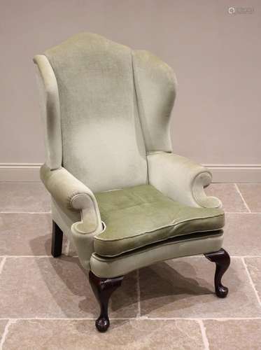 A Queen Anne style wing back armchair, mid 20th century, in ...