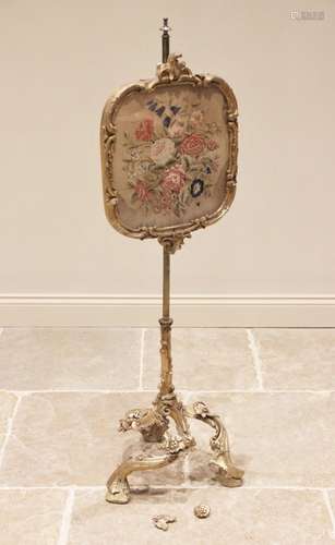 A late 19th century gilt gesso and brass pole screen, the ta...