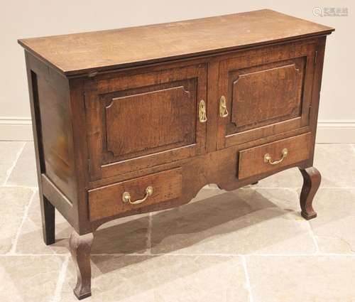 An 18th century and later reconstructed oak sideboard, the l...