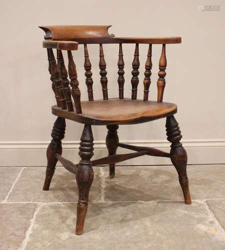 A Victorian elm smokers bow elbow chair, the horse shoe shap...