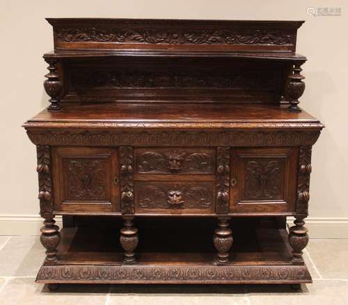 A Victorian carved oak buffet, the superstructure back with ...