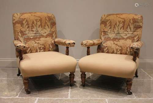 A pair of Victorian lounge armchairs in the manner of Howard...