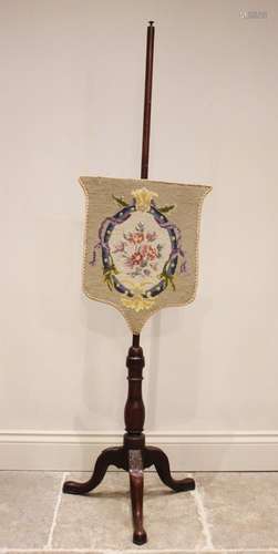 A Victorian mahogany pole screen, the shield shaped floral t...